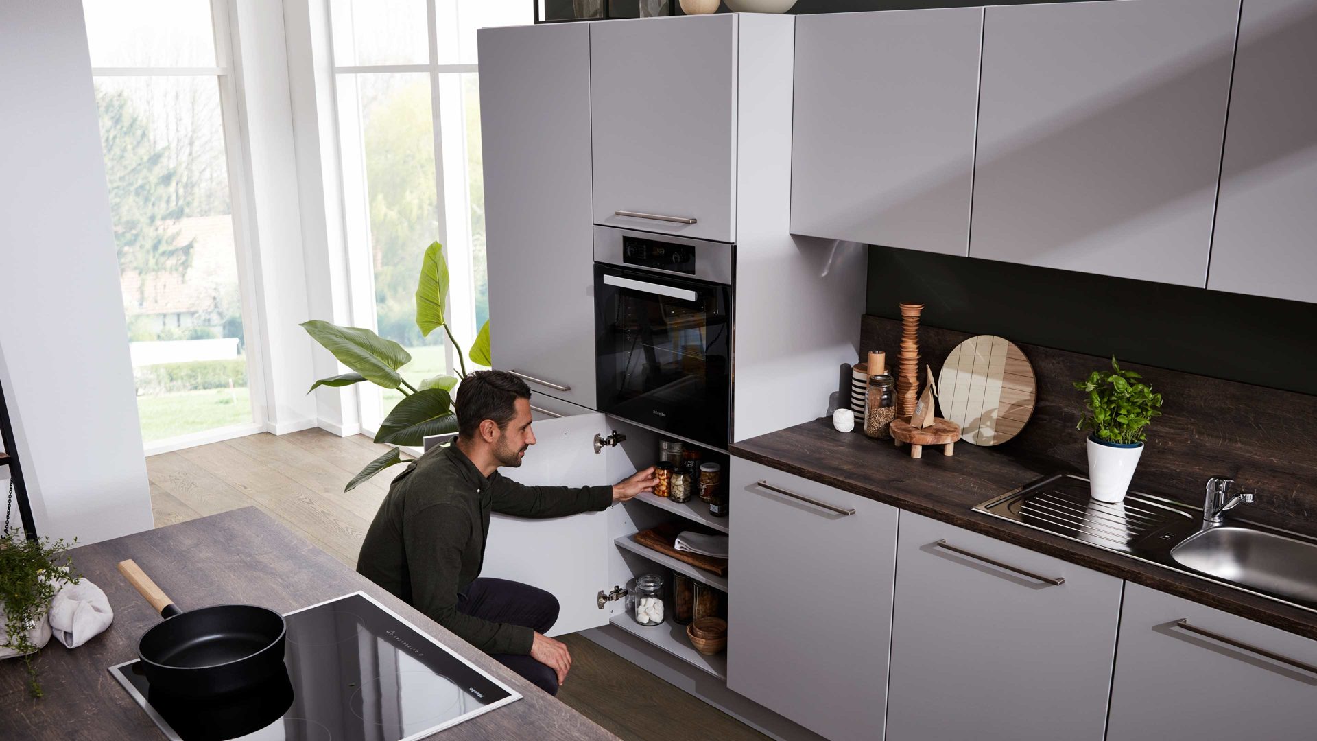 Einbauküche Interliving aus Holz in Grau Interliving Küche Serie 3028 mit Miele-Einbaugeräten Platingrau & Castell Eiche - zweizeilig